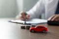 Young man is signing a car loan contract, car trading at workshop Royalty Free Stock Photo