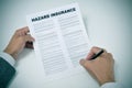 A young man signing a hazard insurance policy Royalty Free Stock Photo