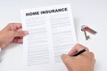A young man signing a home insurance policy