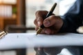 Young man signing an official document, male hand holding pen putting signature at paper contract agreement. Business, lawyer, Royalty Free Stock Photo