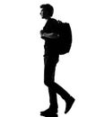 Young man silhouette backpacker walking