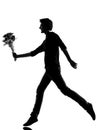 Young man silhouette offering flowers bouquet