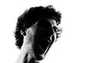 Young man silhouette screaming angry portrait