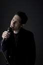 Young man singing into microphone close-up