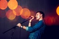 Young Man Singing with Microphone. Royalty Free Stock Photo