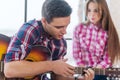 Young man singing playing guitar for his girlfriend Royalty Free Stock Photo