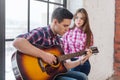 Young man singing playing guitar for his girlfriend Royalty Free Stock Photo