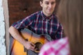 Young man singing playing guitar for his girlfriend Royalty Free Stock Photo