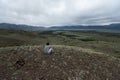 Young man sits on the hill