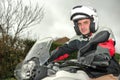 Young man sits on motorcycle and has helmet on his head Royalty Free Stock Photo