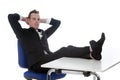Young man sits on office chair with his feet on table Royalty Free Stock Photo