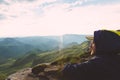 Young Man sitting alone outdoor green valley sunset mountains on background Travel Lifestyle and survival concept Royalty Free Stock Photo