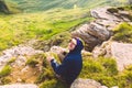 Young smiling Man sitting alone outdoor green valley mountains on background Travel Lifestyle and survival concept Royalty Free Stock Photo