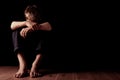 Young man sitting with arms over knees Royalty Free Stock Photo