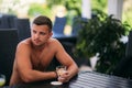 Young man sitting of the beach club bar and drinking tonic Royalty Free Stock Photo