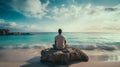 Young man sitting on the beach doing yoga and meditating.Relaxing near the ocean in luxury place. Royalty Free Stock Photo