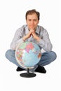 Young man sitting in behind the globe Royalty Free Stock Photo