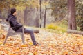 Young man sitting on a bench in a park Royalty Free Stock Photo