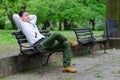 Young man sitting on the bench in the park Royalty Free Stock Photo