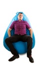 Young man sitting on blue beanbag Royalty Free Stock Photo