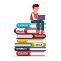 Young man sitting on books stack working on laptop Royalty Free Stock Photo