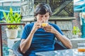 Young man sitting in a cafe drinking a delicious morning ginger Royalty Free Stock Photo