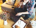 Young man sitting at a cafe, using a tablet