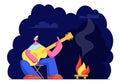 Young Man Sitting at Campfire at Night Time Singing Songs and Playing Guitar. Male Tourist Sparetime in Summer Camp. Summertime Royalty Free Stock Photo