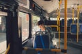 Young man sitting in city bus and reading a book. Royalty Free Stock Photo