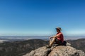 young man sitting on cliff at the Boroka Lookout, Grampians National Park, Australia