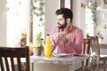 Young man sitting in coffee shop. Royalty Free Stock Photo