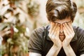 Portrait of a young man covering his eyes. Royalty Free Stock Photo