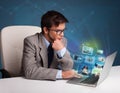 Young man sitting at desk and watching his photo gallery on laptop Royalty Free Stock Photo