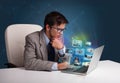 Young man sitting at desk and watching his photo gallery on laptop Royalty Free Stock Photo