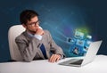 Young man sitting at desk and watching his photo gallery on laptop Royalty Free Stock Photo