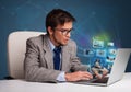 Young man sitting at desk and watching his photo gallery on laptop Royalty Free Stock Photo