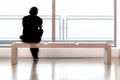 Young Man is sitting on a desk and watching outside