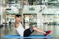 Young man sitting down while doing crunches for the abdominal muscles Royalty Free Stock Photo