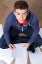 Young man sitting on the floor and learning Royalty Free Stock Photo