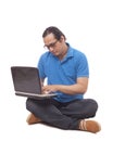 Young Man Sitting on Floor and Typing on Laptop Royalty Free Stock Photo