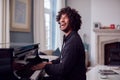 Young Man Sitting At Grand Piano And Playing At Home Royalty Free Stock Photo