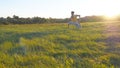 Young man sitting at green grass in the meadow and doing yoga exercise. Muscular guy stretching his body at nature Royalty Free Stock Photo