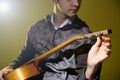 Young man sitting guitar tuning Royalty Free Stock Photo