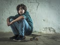 Young man sitting on his skateboard