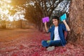 Young man sitting and holding a book in park Royalty Free Stock Photo