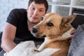Young man sitting at home with his dog Royalty Free Stock Photo
