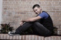 Young man sitting on a ledge