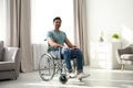 Young man sitting in modern wheelchair