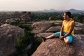 Young man is sitting on the mountain with beautiful view and looking forward Royalty Free Stock Photo