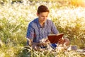 Young man sitting in nature reading a book Royalty Free Stock Photo